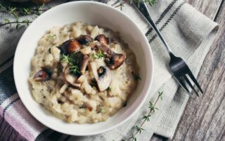 Bowl of Mushroom Risotto garnished with Thyme leaves, selective focus